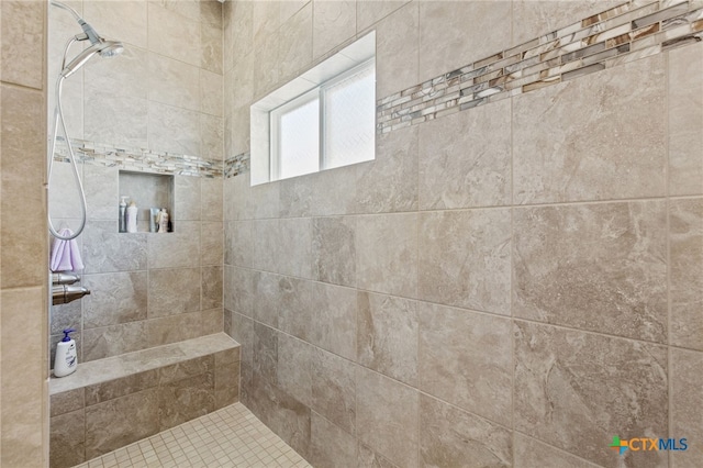 bathroom with a tile shower