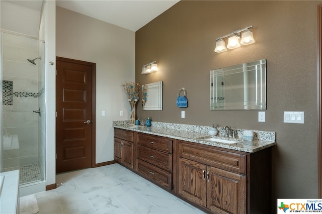 bathroom with walk in shower and vanity