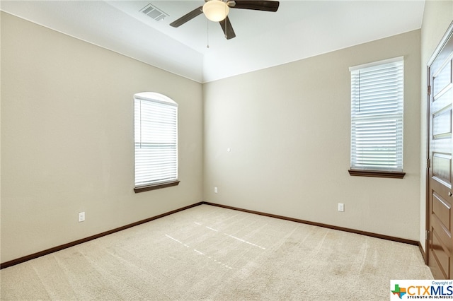 spare room with light carpet and ceiling fan