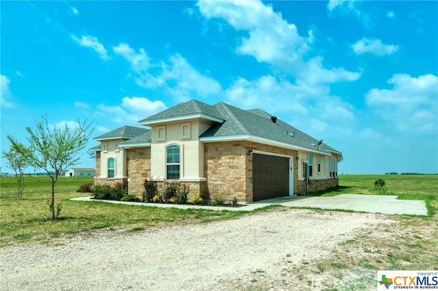 view of front of home with a garage and a front lawn