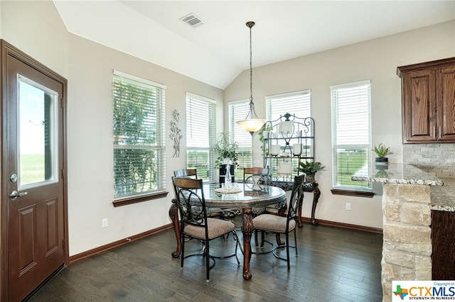 dining space with lofted ceiling and dark hardwood / wood-style floors