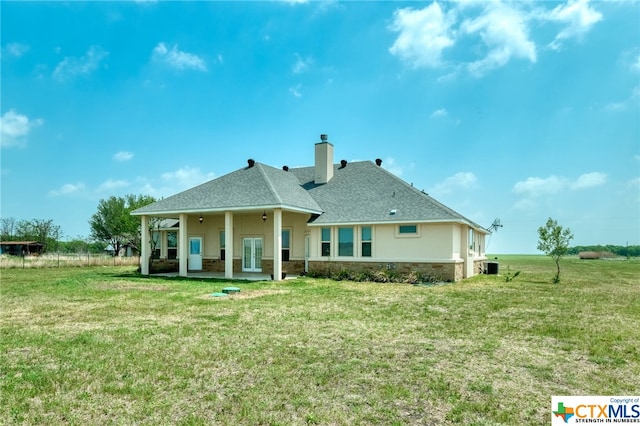 back of house with a lawn