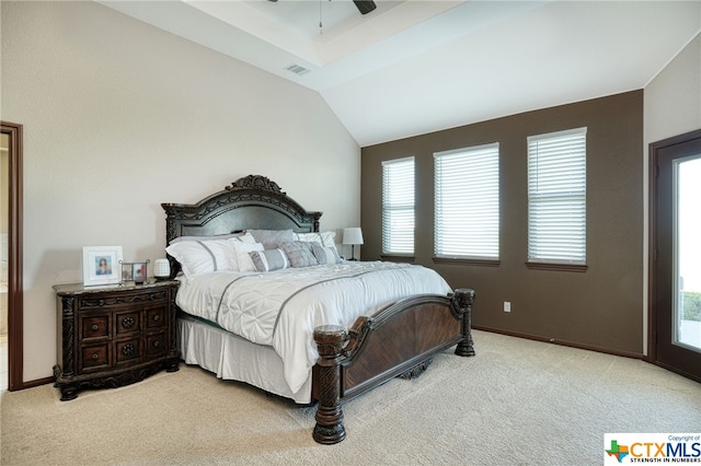 carpeted bedroom featuring multiple windows, ceiling fan, and vaulted ceiling