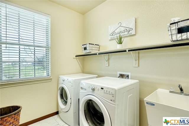 laundry room with plenty of natural light, sink, and washer and dryer