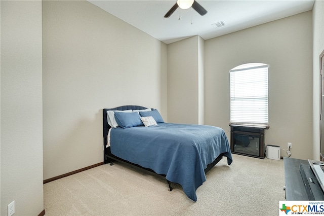 bedroom featuring light colored carpet and ceiling fan