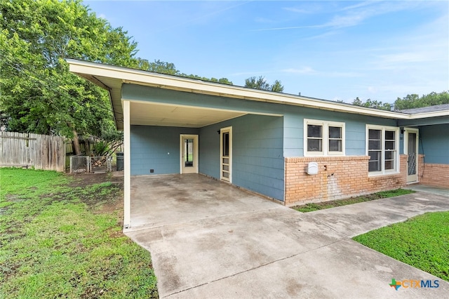 single story home with a front yard and a carport