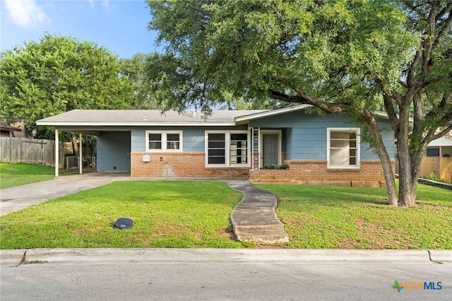 view of front of property featuring a carport and a front lawn