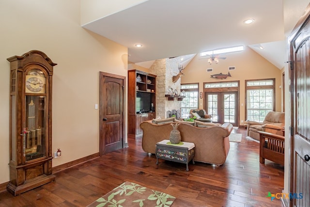 living room with french doors, a fireplace, dark hardwood / wood-style floors, high vaulted ceiling, and ceiling fan