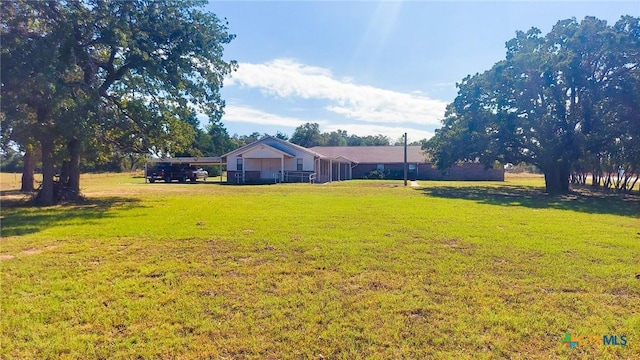126 County Road 232nd Loop, Rockdale, TX 76567 - view of green lawn featuring a carport