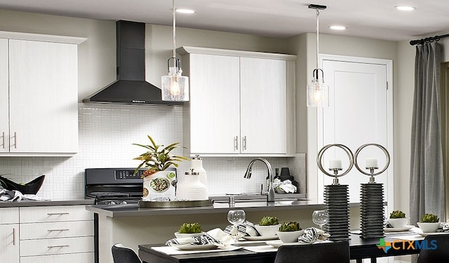 212 Torchwood Dr, Marble Falls, TX 78654 - kitchen with wall chimney range hood, dark countertops, pendant lighting, decorative backsplash, and recessed lighting