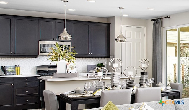 212 Torchwood Dr, Marble Falls, TX 78654 - kitchen with appliances with stainless steel finishes, light countertops, decorative backsplash, hanging light fixtures, and recessed lighting