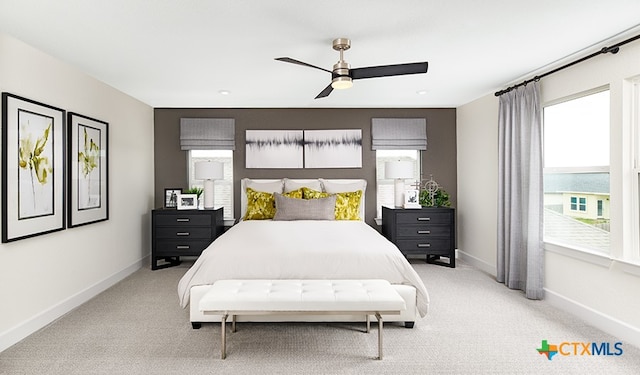 212 Torchwood Dr, Marble Falls, TX 78654 - bedroom featuring multiple windows, baseboards, light carpet, and a ceiling fan