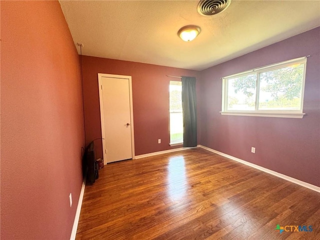 spare room with wood-type flooring