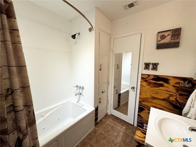 bathroom with tile patterned floors, shower / bath combo, and sink