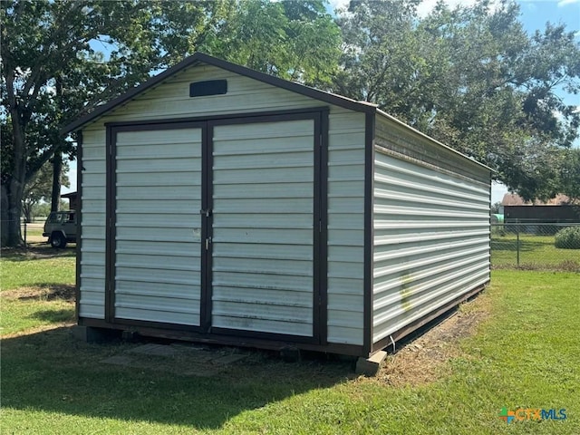 view of outdoor structure featuring a lawn