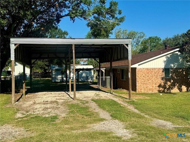 exterior space featuring a yard and a carport