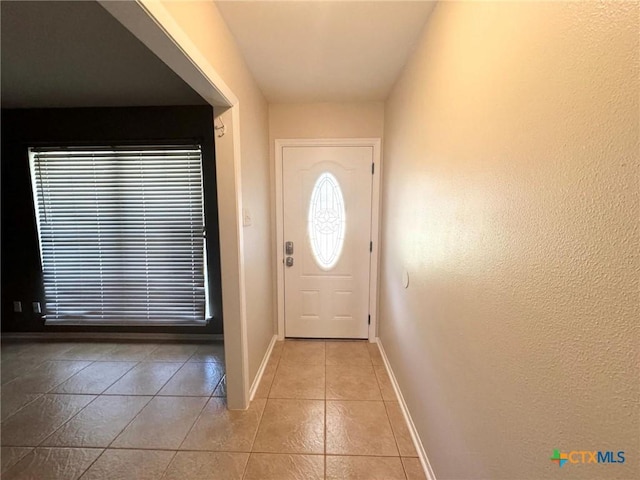 doorway to outside featuring light tile patterned floors