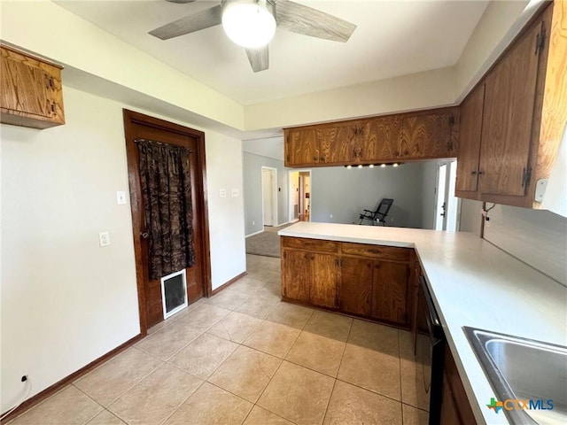 kitchen featuring sink, kitchen peninsula, light tile patterned flooring, and ceiling fan