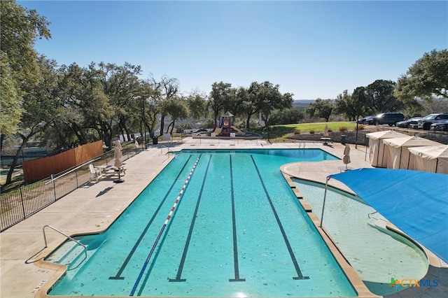 view of pool featuring a patio area and a playground