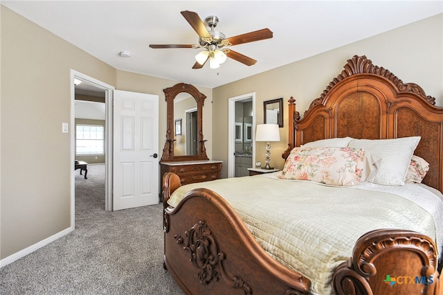 bedroom featuring ceiling fan, ensuite bath, and carpet floors