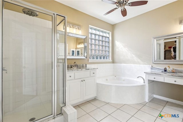 bathroom with ceiling fan, tile patterned floors, plus walk in shower, and vanity