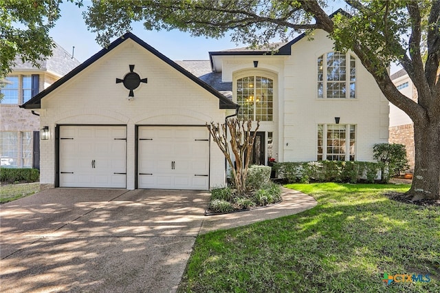 view of front of home featuring a garage and a front lawn