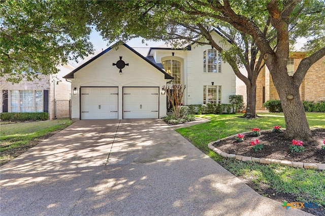 view of front of property with a garage and a front yard