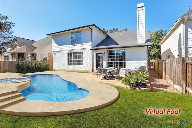 rear view of house with a swimming pool with hot tub, a patio, and a lawn