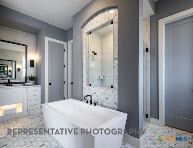 bathroom with vanity and independent shower and bath