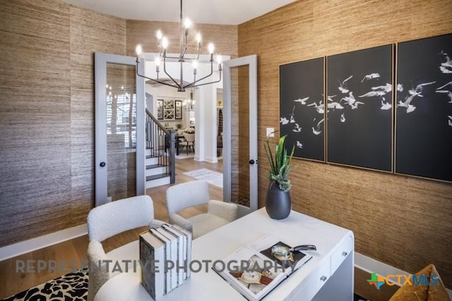 interior space with wood-type flooring and an inviting chandelier