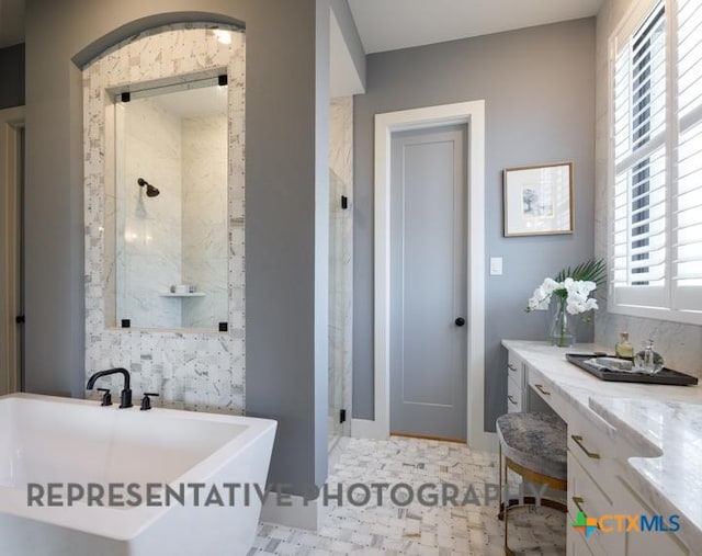 bathroom featuring vanity and separate shower and tub