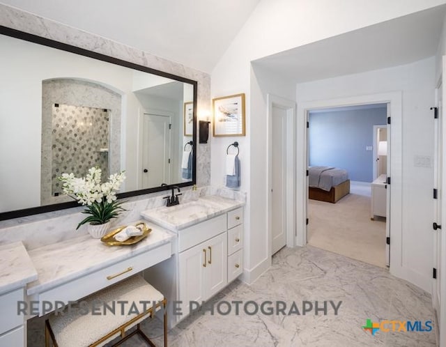 bathroom with vanity, lofted ceiling, and walk in shower