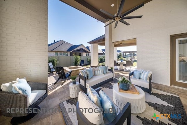 view of patio with an outdoor living space and ceiling fan