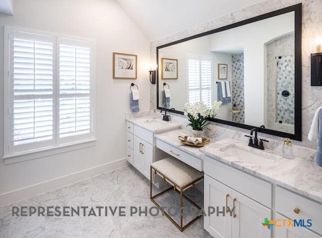 bathroom with vanity and vaulted ceiling