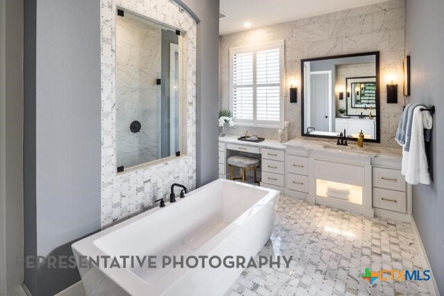 bathroom with vanity and independent shower and bath