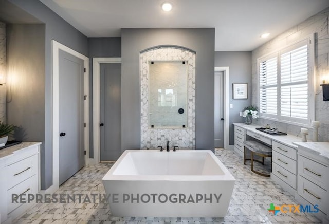 bathroom featuring vanity and a washtub