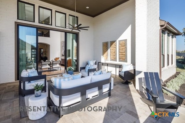 view of patio with ceiling fan and an outdoor living space