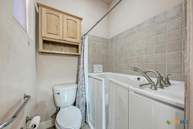 bathroom with a shower with curtain, toilet, and a bathing tub