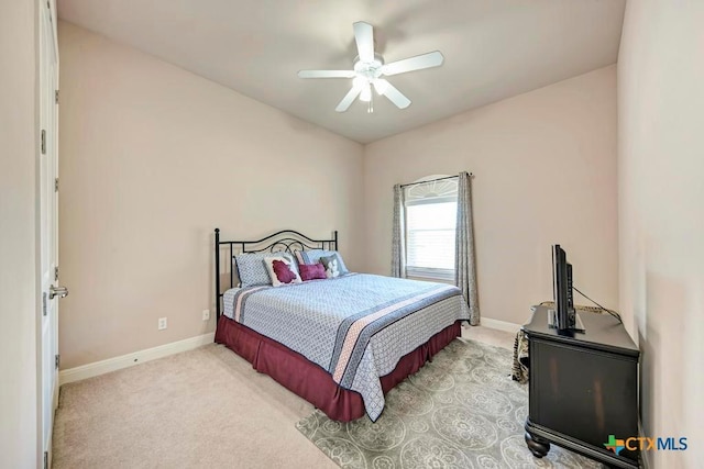 carpeted bedroom featuring a ceiling fan and baseboards