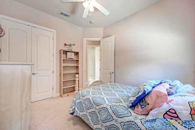 bedroom with a ceiling fan, visible vents, light carpet, and baseboards
