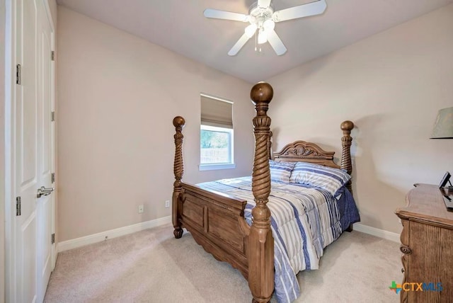 bedroom featuring light carpet, a ceiling fan, and baseboards