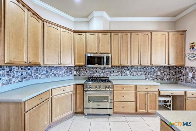 kitchen with appliances with stainless steel finishes, light countertops, decorative backsplash, and light tile patterned flooring
