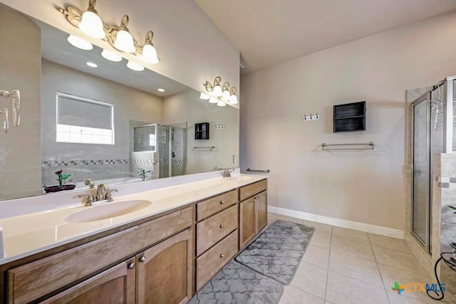bathroom with double vanity, tile patterned flooring, a shower stall, and a sink