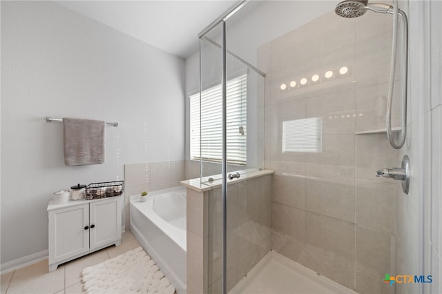 full bathroom with a garden tub, a shower stall, and tile patterned flooring