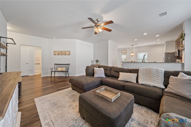 living room featuring visible vents, a ceiling fan, dark wood finished floors, recessed lighting, and baseboards