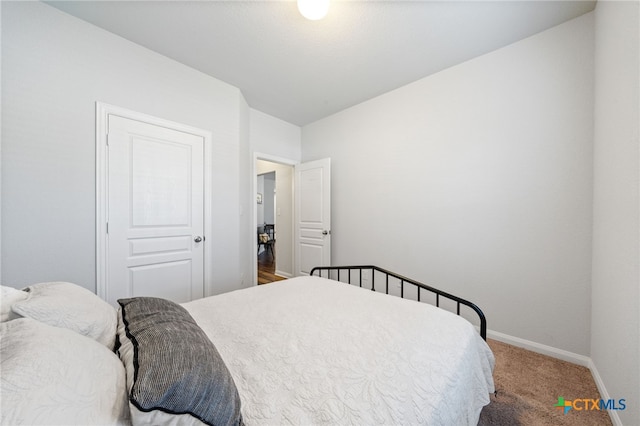 carpeted bedroom featuring baseboards