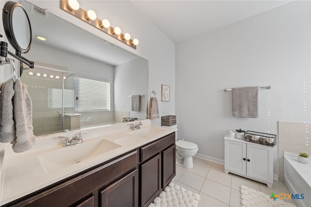 full bath featuring a bath, tile patterned floors, double vanity, and a sink