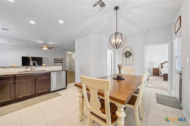 kitchen with visible vents, dark brown cabinets, stainless steel dishwasher, light tile patterned flooring, and a sink