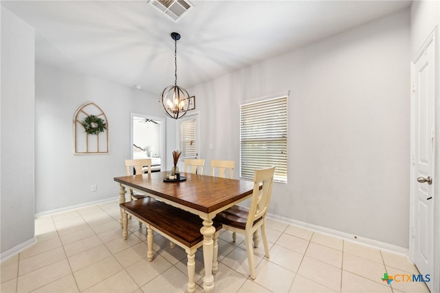 dining space featuring light tile patterned floors, visible vents, baseboards, and an inviting chandelier