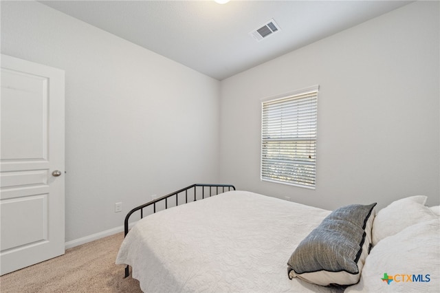 bedroom with baseboards, visible vents, and carpet floors